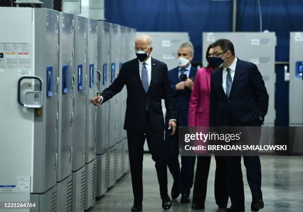 President Joe Biden , with Michigan Governor Gretchen Whitmer and Pfizer CEO Albert Bourla , tours Covid-19 vaccine freezers at a Pfizer...