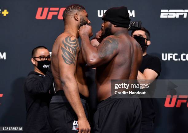 In this UFC handout, Opponents Curtis Blaydes and Derrick Lewis face off during the UFC weigh-in at UFC APEX on February 19, 2021 in Las Vegas,...