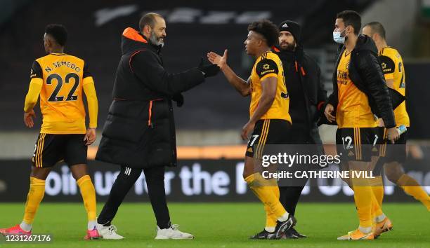 Wolverhampton Wanderers' Portuguese head coach Nuno Espirito Santo congratulates Wolverhampton Wanderers' Spanish midfielder Adama Traore after the...