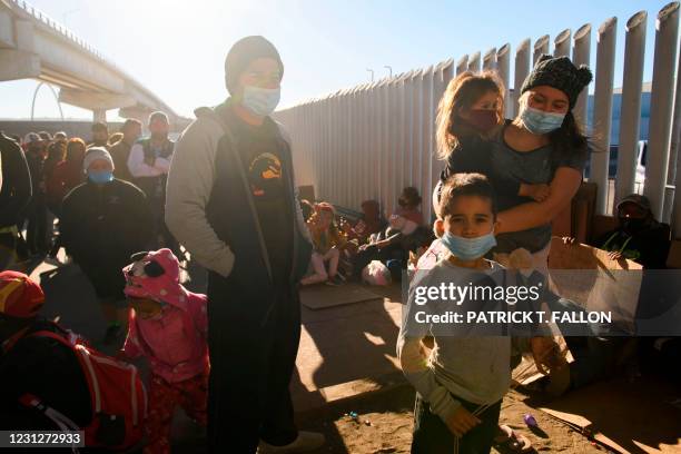 Asylum seekers from countries including Honduras wait outside the El Chaparral border crossing port as they wait to cross into the United States in...