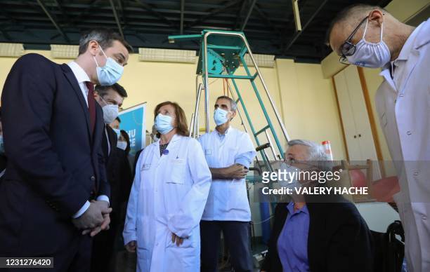 French Health Minister Olivier Veran speaks with Claude Maschi , a recovered patient with coronavirus, during a visit at the CHU Hospital in Nice,...
