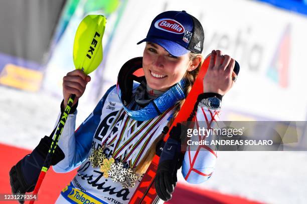 Third-placed US Mikaela Shiffrin celebrates with her medals at the end of the podium ceremony after competing in the first and second run of the...