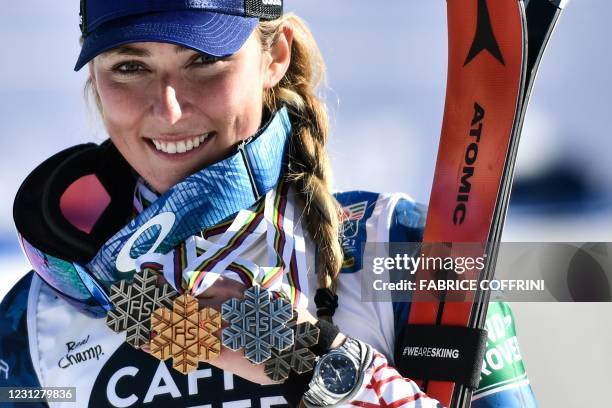 Third-placed US Mikaela Shiffrin celebrates with her medals at the end of the podium ceremony after competing in the first and second run of the...