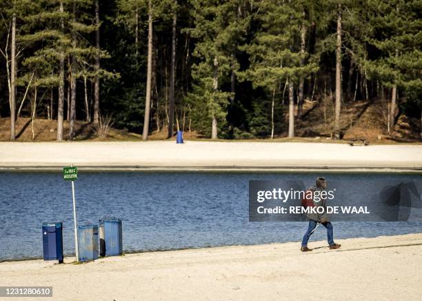 Woman walks in the Henschotermeer park in Woudenberg, on a sunny day, on February 20, 2021. / Netherlands OUT