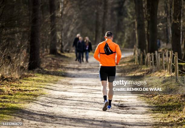 Man runs nears the Pyramid of Austerlitz, a monument in Woudenberg, on February 20, 2021. / Netherlands OUT