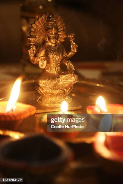 Diyas by an idol of the Goddess Laxmi during the festival of Diwali at a Hindu temple in Toronto, Ontario, Canada, on November 14, 2020.
