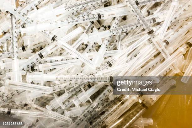 Syringes sit ready to be filled with the Pfizer-BioNTech COVID-19 vaccine during a mass vaccination event in the parking lot of Coors Field on...