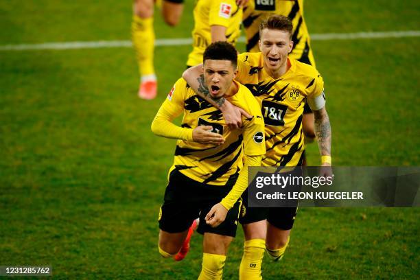 Dortmund's English midfielder Jadon Sancho and Dortmund's German forward Marco Reus celebrate the 0-1 during the German first division Bundesliga...