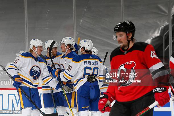 Sam Reinhart of the Buffalo Sabres is congratulated by his teammates after scoring a goal as Sami Vatanen of the New Jersey Devils reacts during the...