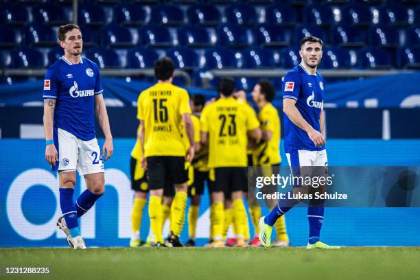 Bastian Oczipka and Sead Kolasinac of Schalke look disappointed after getting the second goal during the Bundesliga match between FC Schalke 04 and...