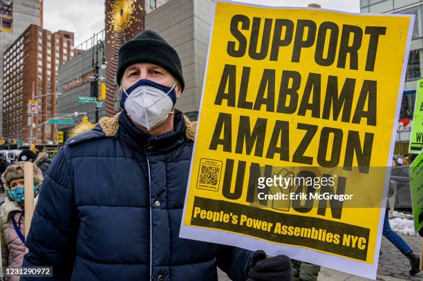 Participant seen holding a sign at the protest. Members of the Workers Assembly Against Racism gathered across from Jeff Bezos-owned Whole Foods...