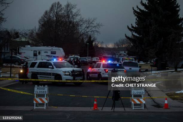 Police tape blocks a street where debris fallen from a United Airlines airplane's engine lay scattered through the neighborhood of Broomfield,...