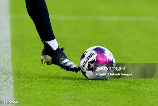 A foot and a match ball are seen during the Second Bundesliga match between Hamburger SV and SpVgg Greuther Fuerth at Volksparkstadion on February...