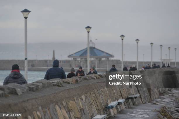 People walking on the East Pier in Dun Laoghaire during Level 5 Covid-19 lockdown. On Saturday, February 20 in Dún Laoghaire, Dublin, Ireland.