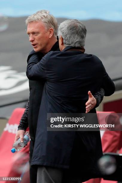 Tottenham Hotspur's Portuguese head coach Jose Mourinho greets West Ham United's Scottish manager David Moyes during the English Premier League...