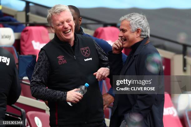 West Ham United's Scottish manager David Moyes and Tottenham Hotspur's Portuguese head coach Jose Mourinho share a joke ahead of kick off in the...