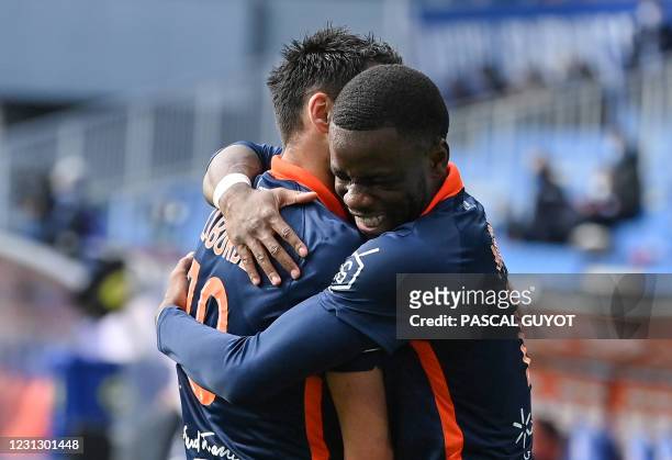 Montpellier's English forward Stephy Mavididi is congratulated by his teammate French forward Gaetan Laborde after scoring a goal during the French...