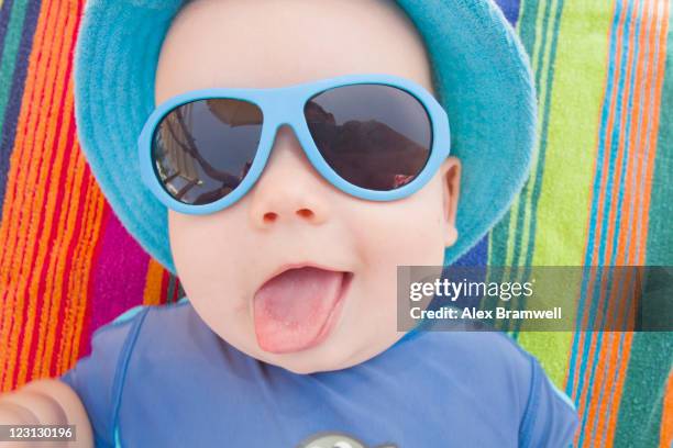 baby boy with sun hat and sunglasses - baby sun hat stock-fotos und bilder