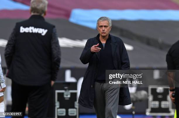 Tottenham Hotspur's Portuguese head coach Jose Mourinho gestures to West Ham United's Scottish manager David Moyes on thetouchline during the English...