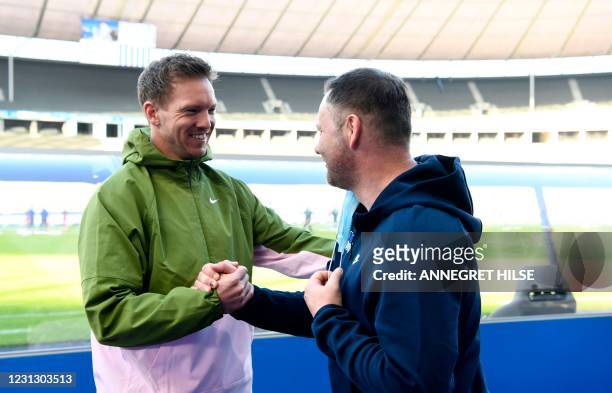 Leipzig's German headcoach Julian Nagelsmann and Hertha Berlin's Hungarian head coach Pal Dardai shake hands prior to the German first division...