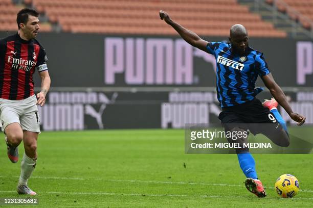 Inter Milan's Belgian forward Romelu Lukaku shoots to score the third goal during the Italian Serie A football match AC Milan vs Inter Milan on...