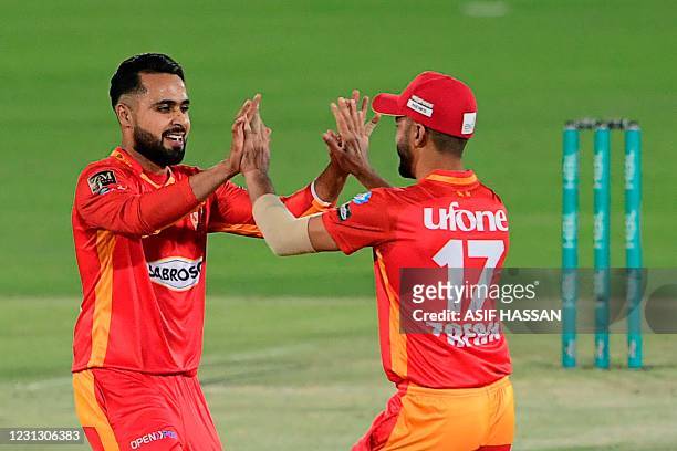 Islamabad United's Faheem Ashraf celebrates with teammate the wicket of Multan Sultan's Chris Lynn during the Pakistan Super League T20 cricket match...