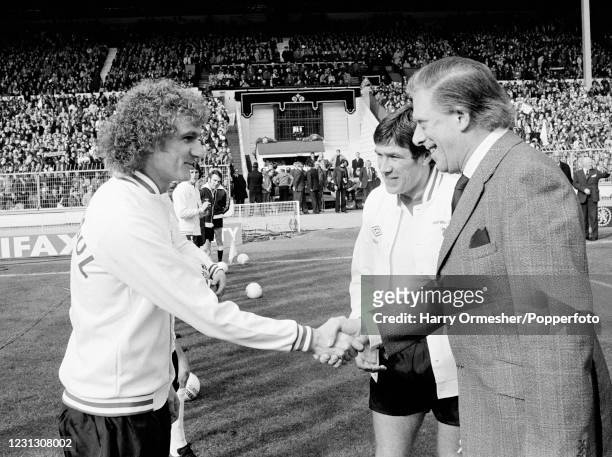 Liverpool captain Emlyn Hughes introduces Phil Thompson to the guest of honour the Earl of Harewood before the League Cup Final between Nottingham...