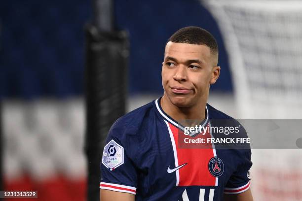 Paris Saint-Germain's French forward Kylian Mbappe reacts after missing a shot during the French L1 football match between Paris-Saint Germain and AS...
