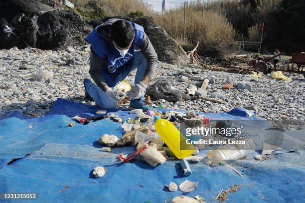 Researcher examines plastics and microplastic found on the beaches while conducting brand audit work on February 21, 2021 in Livorno, Italy. The...