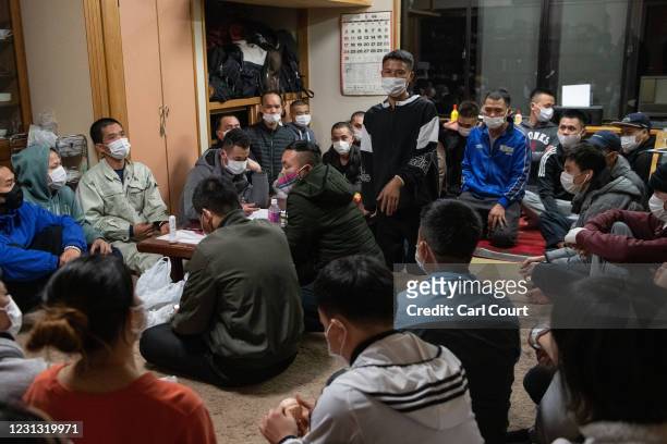 Vietnamese migrant workers made jobless and homeless by the coronavirus pandemic meet to discuss chores at Daionji Temple on February 20, 2021 in...