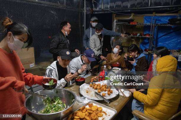 Vietnamese migrant workers made jobless and homeless by the coronavirus pandemic enjoy dinner at Daionji Temple on February 20, 2021 in Honjo, Japan....