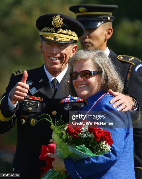 Gen. David Petraeus reacts to applause with his wife, Holly Petraeus, during an Armed Forces Farewell Tribute and Retirement Ceremony August 31, 2011...