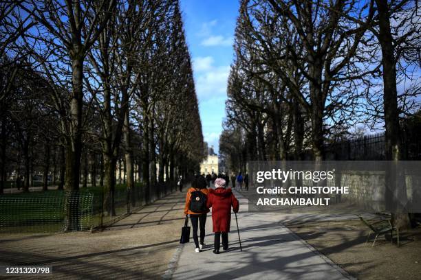 Year-old retiree Genevieve Dupaquier walks with student Dilara Ekinci during a stroll organised by the 'Paris en compagnie' association, at the...