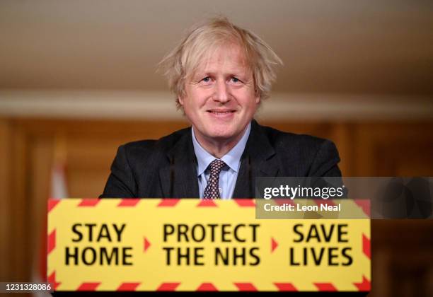 British Prime Minister Boris Johnson smiles during a televised press conference at 10 Downing Street on February 22, 2021 in London, England. The...