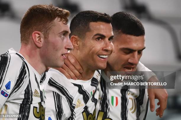 Juventus' Portuguese forward Cristiano Ronaldo celebrates with Juventus' Swedish forward Dejan Kulusevski and Juventus' Turkish defender Merih...