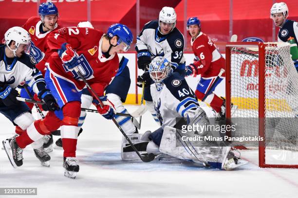 Goaltender Mikhail Berdin of the Manitoba Moose makes a pad save near Lukas Vejdemo of the Laval Rocket during the second period at the Bell Centre...