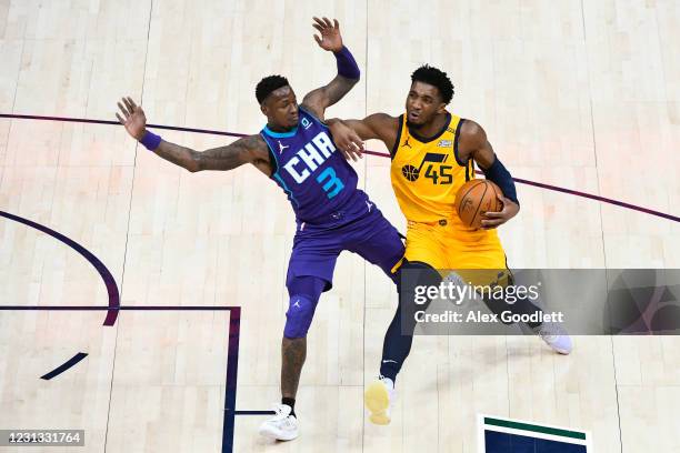 Donovan Mitchell of the Utah Jazz drives into Terry Rozier of the Charlotte Hornets during a game at Vivint Smart Home Arena on February 22, 2021 in...