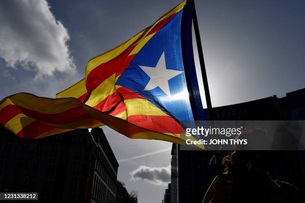 Protestor waves a Catalonia's flag during a gathering, in front of the European Union Commission, in Brussels, on February 23 and called by the...