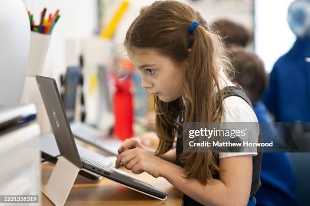 Child uses a laptop at Roath Park Primary School on February 23, 2021 in Cardiff, Wales. Children aged three to seven began a phased return to school...