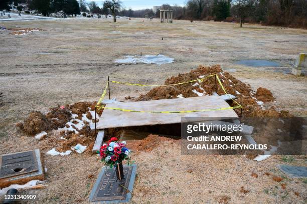 Grave is seen as it is being renovated early in the morning at a cemetery in Hyattsville, Maryland on February 23, 2021. - More than 500,000 people...