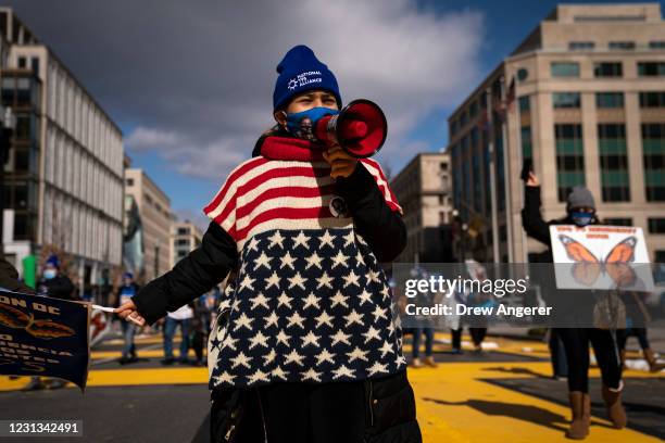 Activists and citizens with temporary protected status march along 16th Street toward the White House in a call for Congress and the Biden...