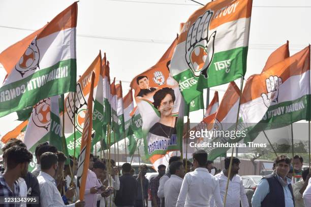 Congress flags featuring Rahul and Priyanka Gandhi being carried by Congress workers at a reception for the latter at DND Noida during her visit to...