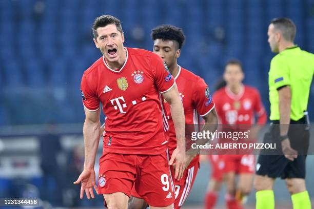 Bayern Munich's Polish forward Robert Lewandowski celebrates after opening the scoring during the UEFA Champions League round of 16 first leg...