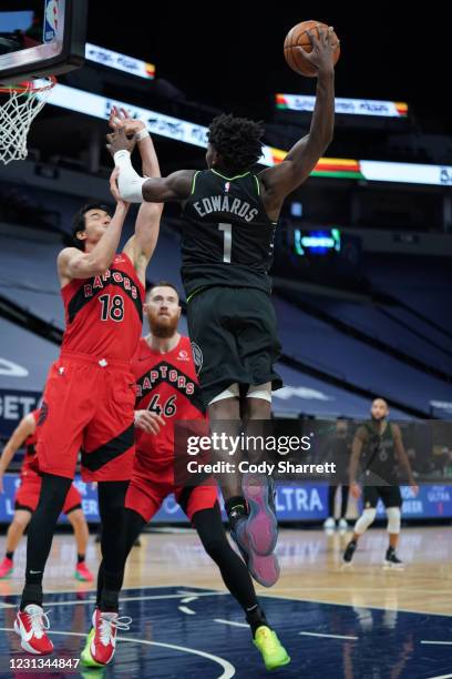 Anthony Edwards of the Minnesota Timberwolves dunks the ball on Yuta Watanabe of the Toronto Raptors on February 19, 2021 at Target Center in...