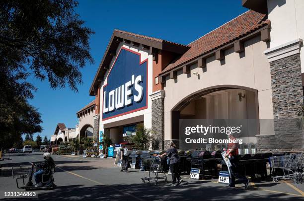 Customers wearing protective masks outside a Lowe's store in Concord, California, U.S., on Tuesday, Feb. 23, 2021. Lowe's Cos Inc. Is expected to...