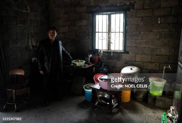 This picture taken on January 12, 2021 shows farmer Liu Qingyou at his residence in Baojing County, in central China's Hunan province. - China's...