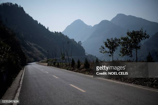 This picture taken on January 13, 2021 shows part of the 63 kilometre-long Qianqing road in Baojing county, in central China's Hunan province. -...