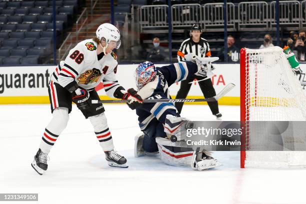 Joonas Korpisalo of the Columbus Blue Jackets stops a shot by Patrick Kane of the Chicago Blackhawks during the shootout at Nationwide Arena on...