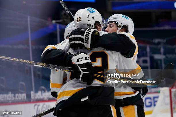 Kasperi Kapanen of the Pittsburgh Penguins celebrates with his teammates after scoring the game winning goal against the Washington Capitals in...