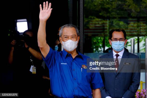 Muhyiddin Yassin, Malaysia's prime minister, waves as he arrives to receive the Pfizer-BioNTech Covid-19 vaccine at the district health office in...
